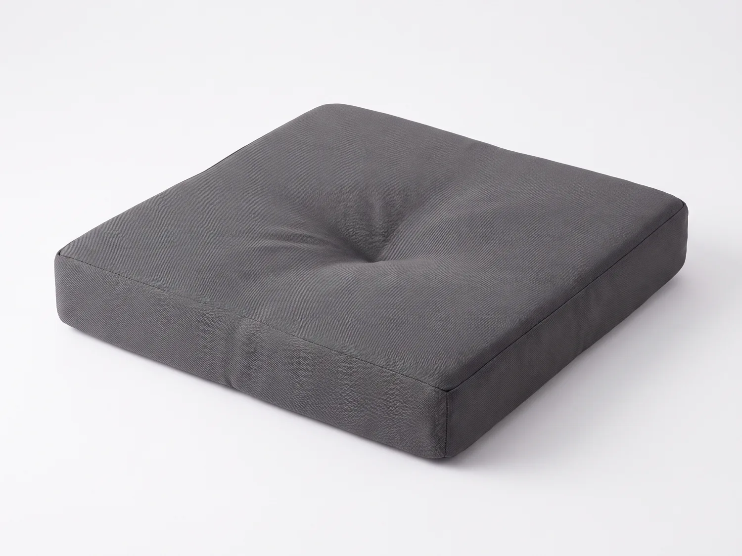 A standard grey memory-foam travel cushion, sagging in the middle after use