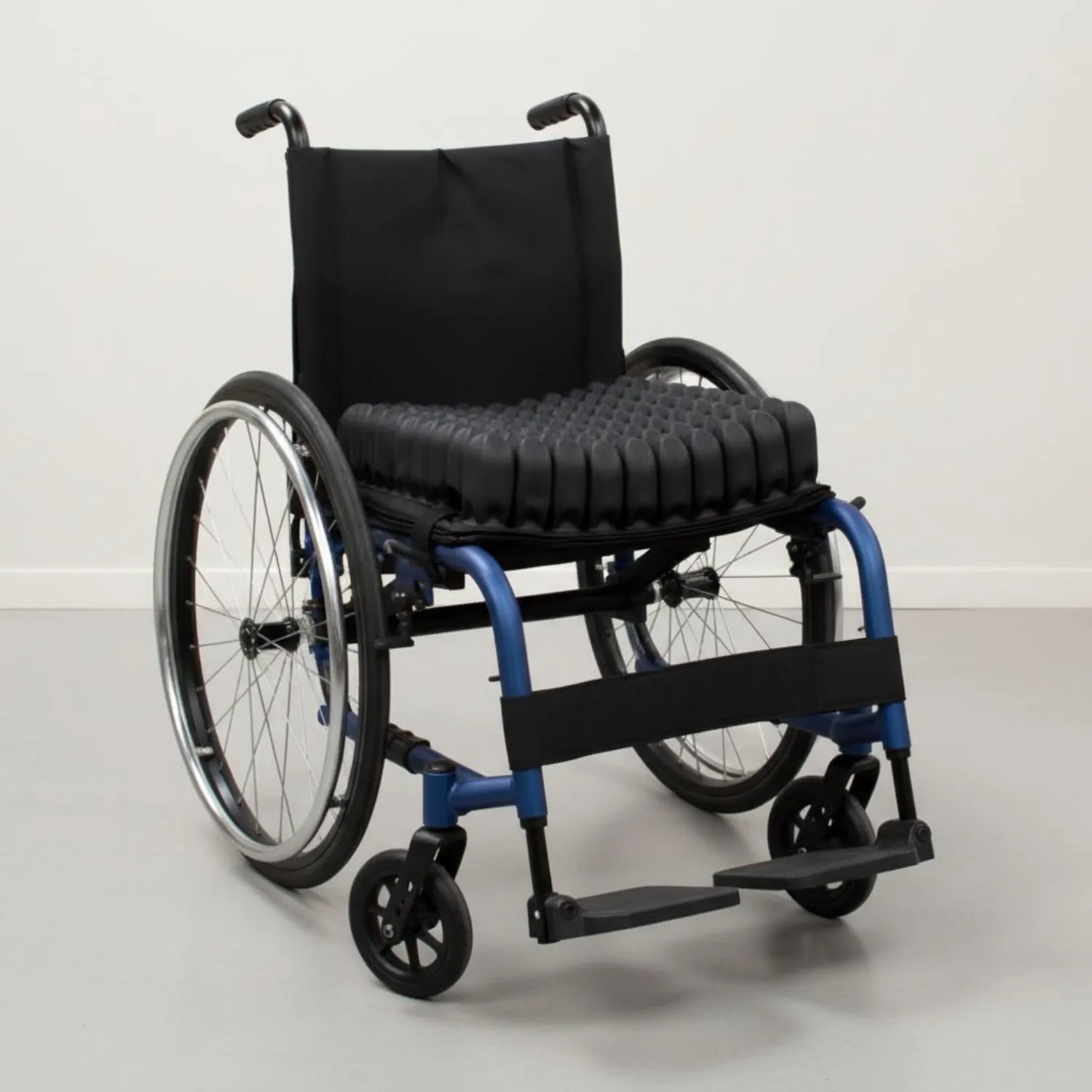 A wheelchair fitted with the interconnected air-cell cushion used in hospitals